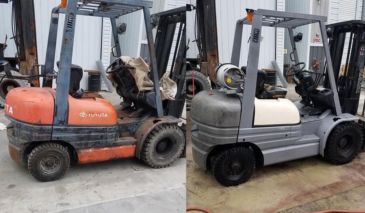 Two forklifts are parked next to each other in front of a building