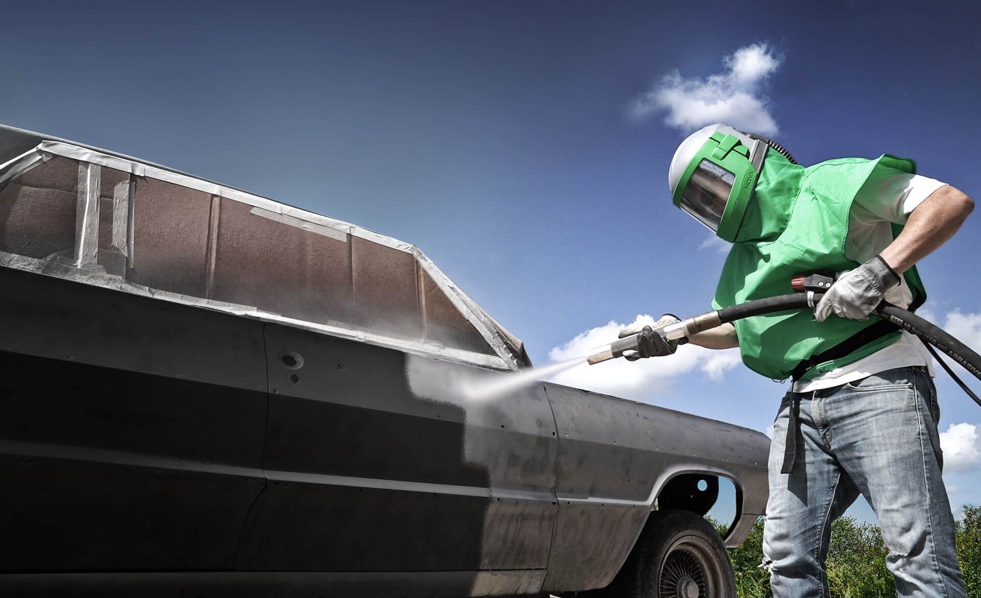 A WNY Air Blasting technician dustless blasting paint from a classic car