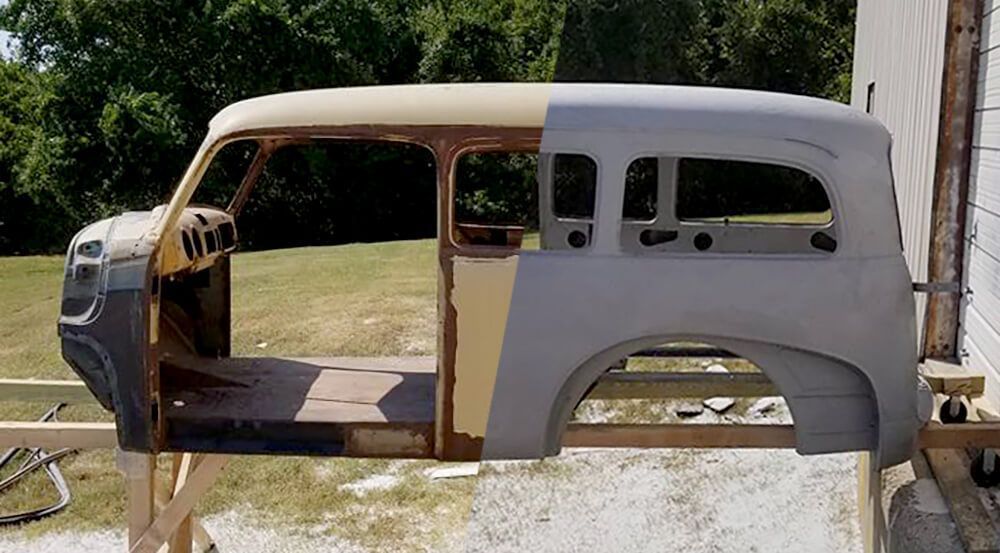A car body is sitting on a wooden stand.