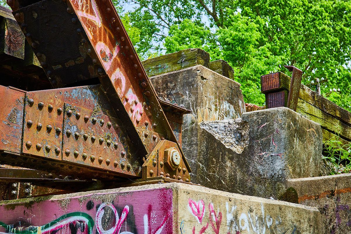 A car body is sitting on a wooden stand.